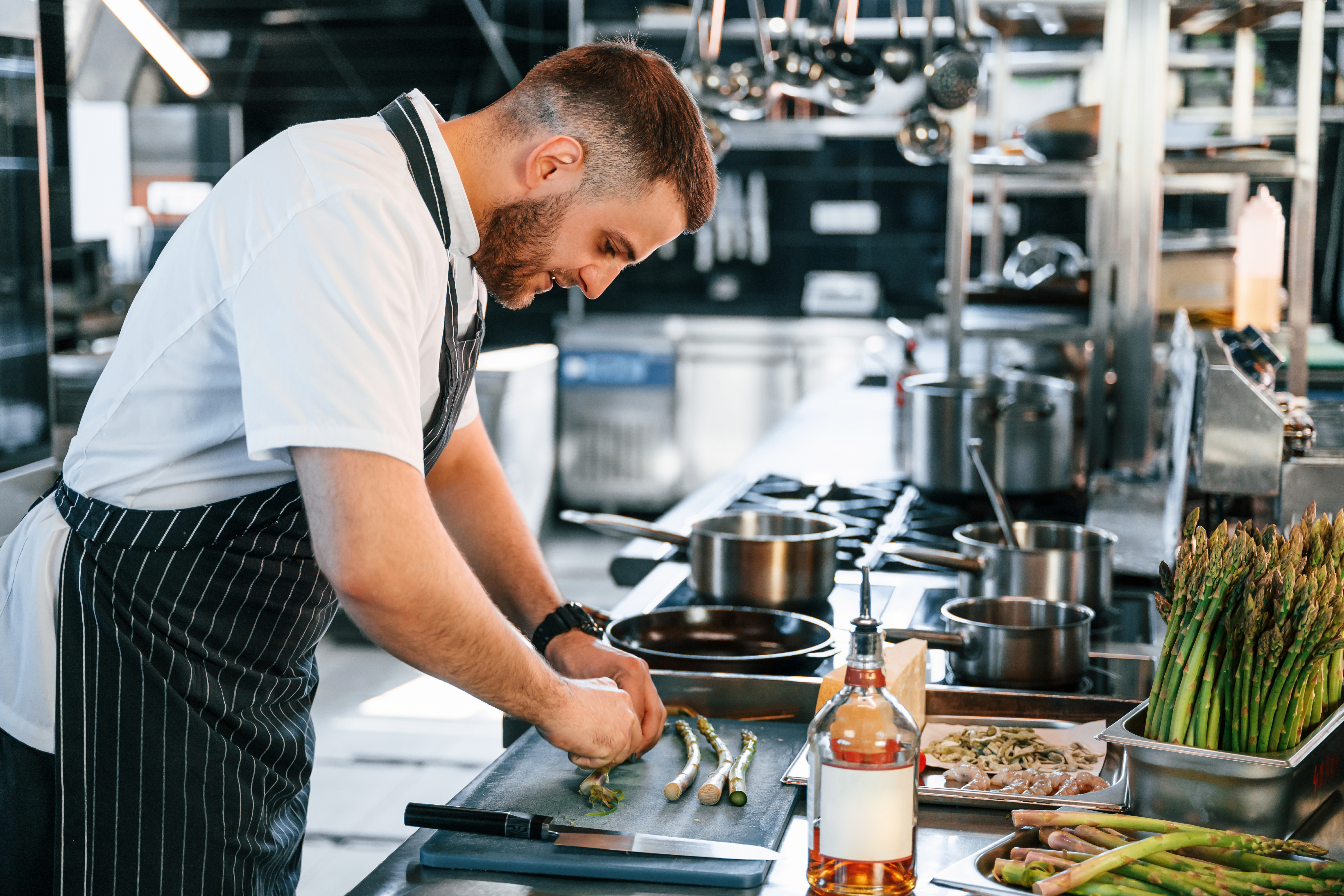 slicing-cutting-asparagus-chef-is-kitchen-preparing-food